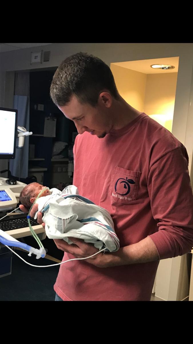 father holding newborn